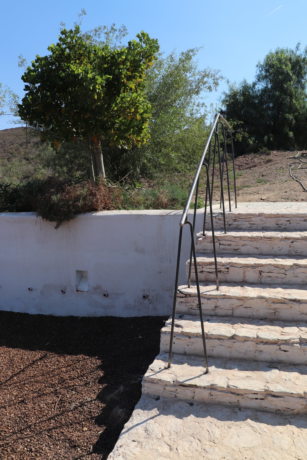 16mm roundbar balustrade — hairpin handrail running up the stone steps