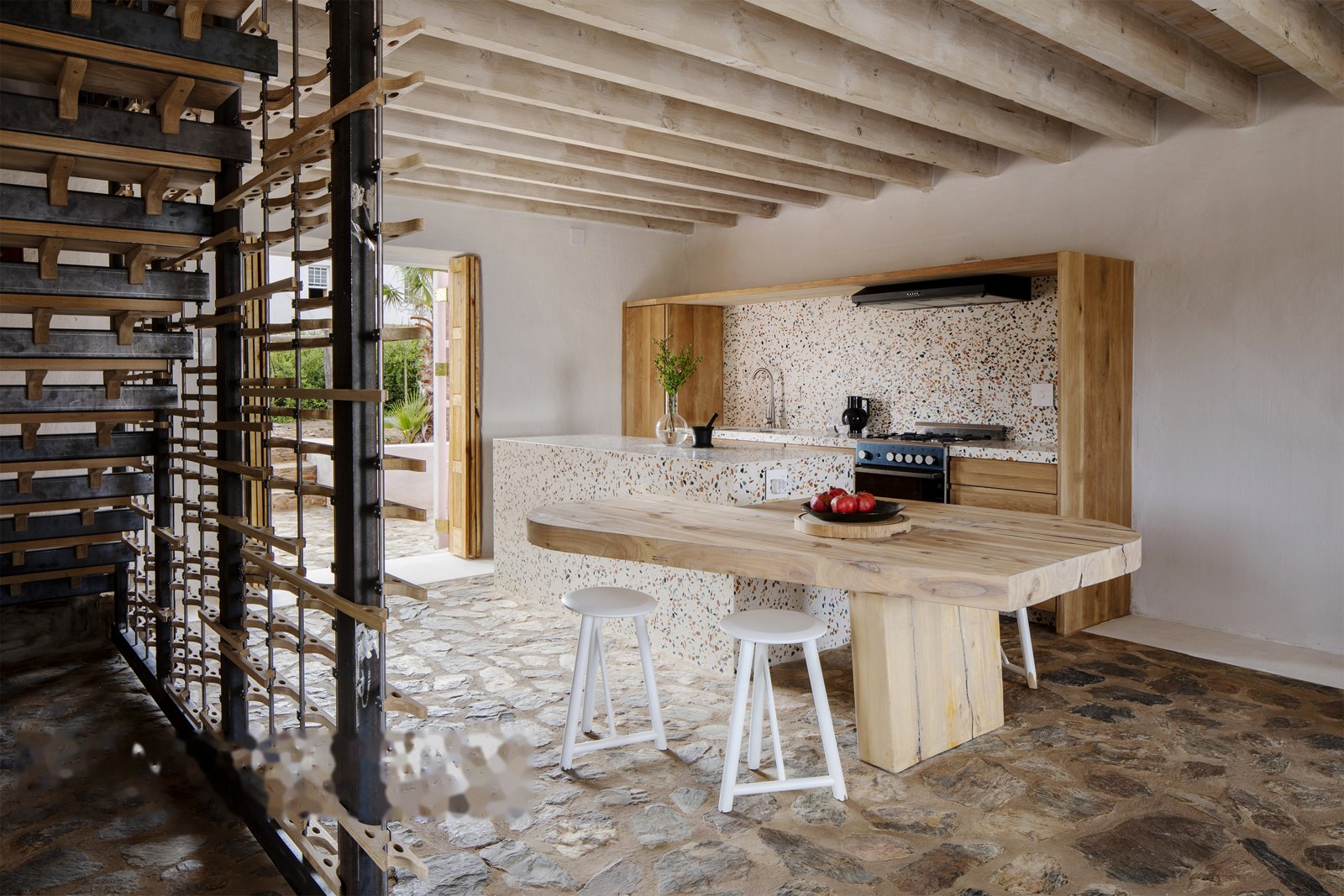 Folded-plate and waterjet-oak staircase — oak screen against the terrazzo kitchen