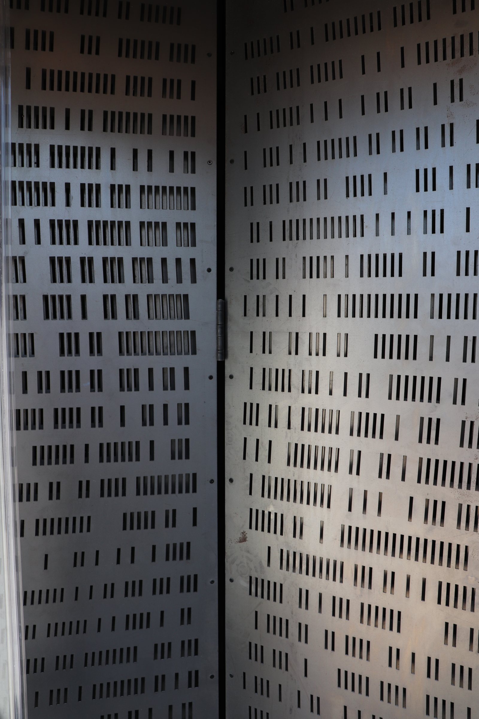 Double-plate perforated steel sliding screen — apertures in and out of register