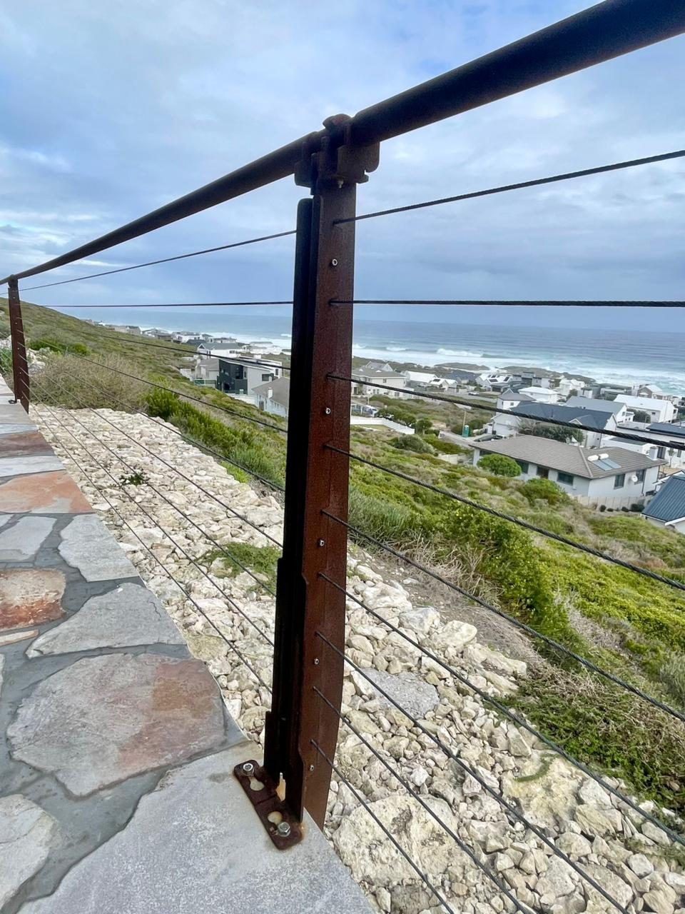 Folded plate balustrade — Yzerfontein, folded steel upright along the path