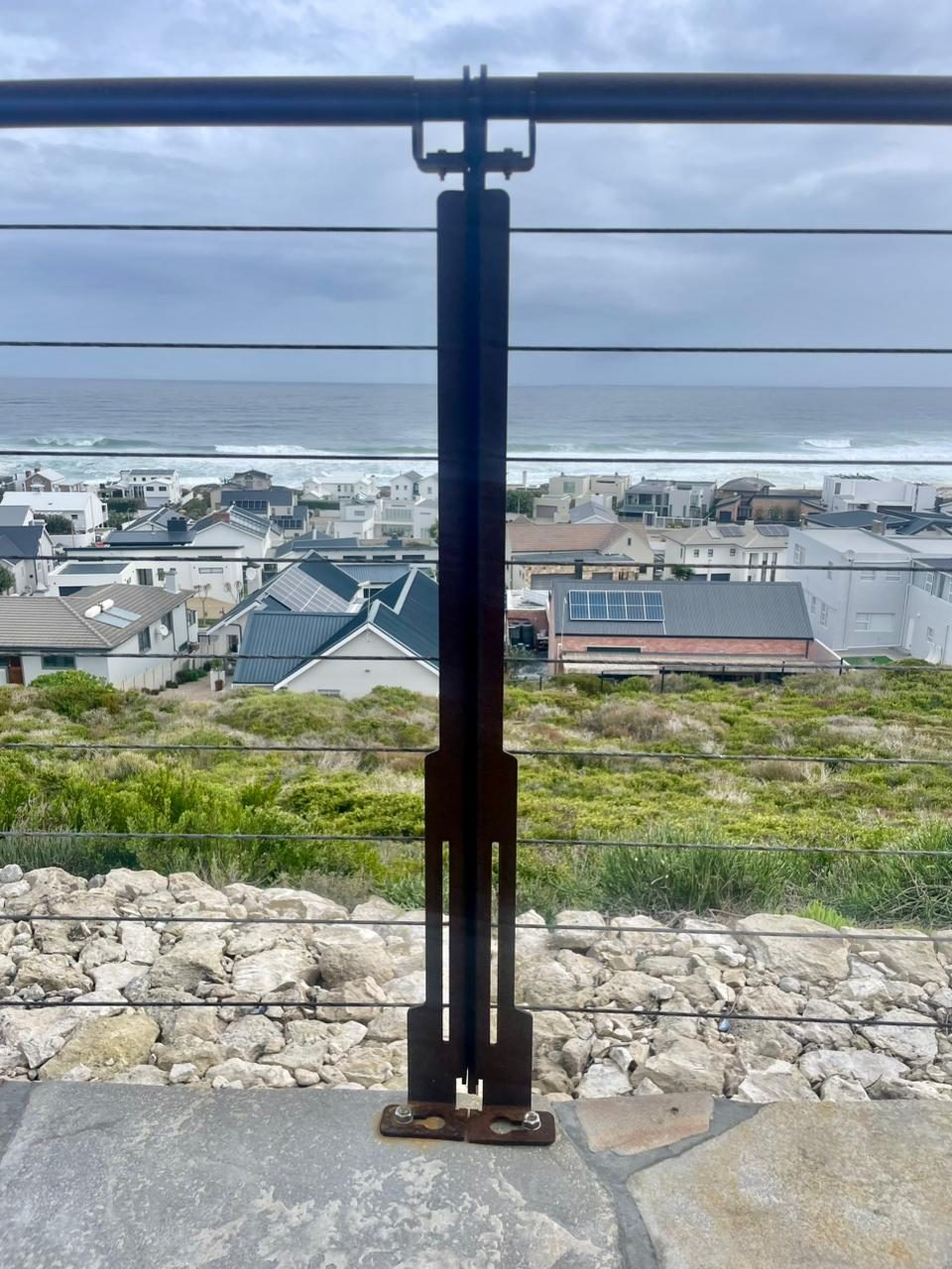 Folded plate balustrade — folded upright seen edge-on over the sea
