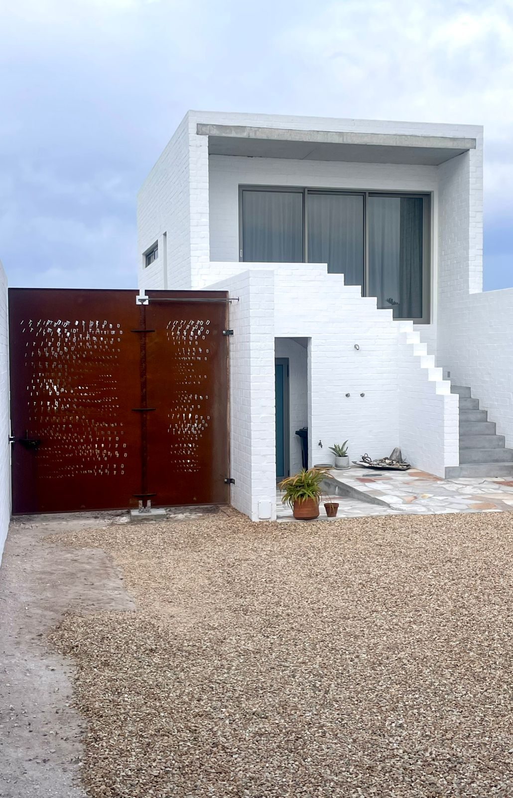 Laser-cut pivot steel entrance door — installed, House Yzerfontein