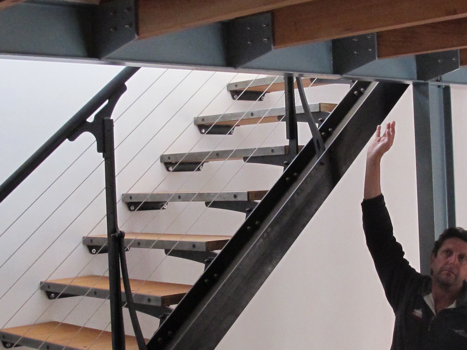 Bamboo plywood treads on machined steel brackets, tension-cable balustrade