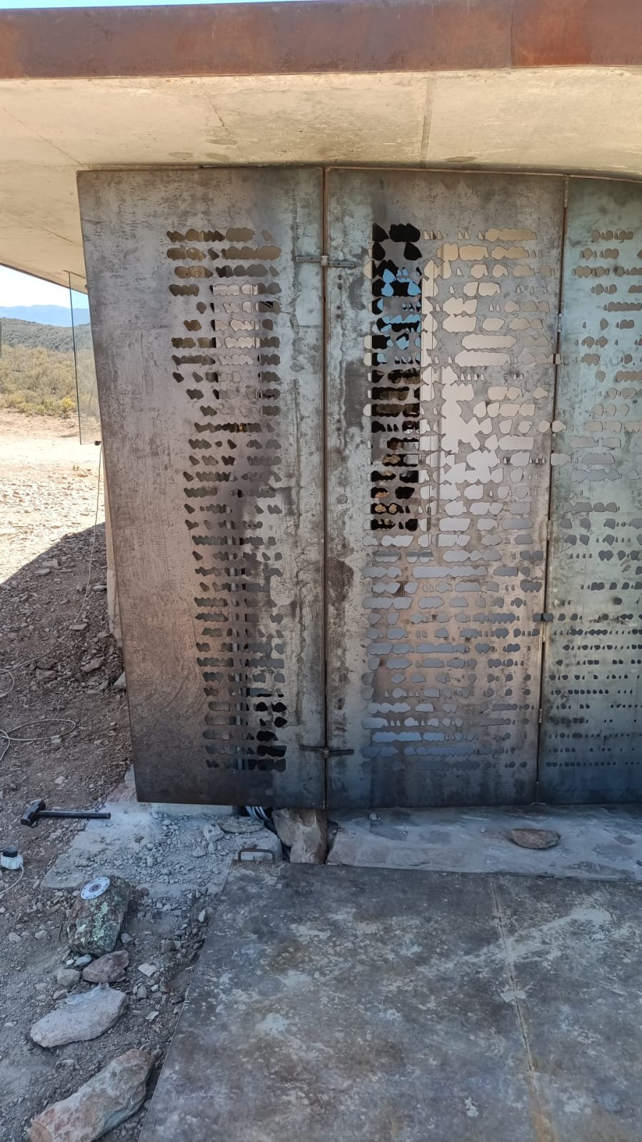 Laser-cut geyser screen — installed in the concrete niche, Buffelsdrift