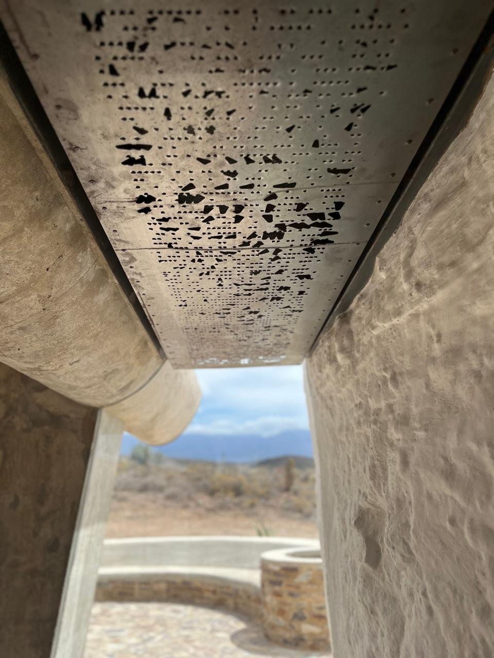 Laser-perforated concrete ceiling — apertures from the pointcloud scan, view to the Karoo
